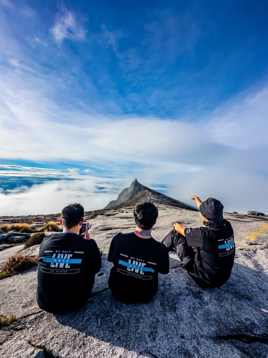 Kay Du and fellow hikers at a mountain summit in Malaysia