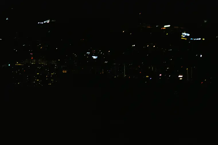 Frame 5, a night shot with only a few city lights visible