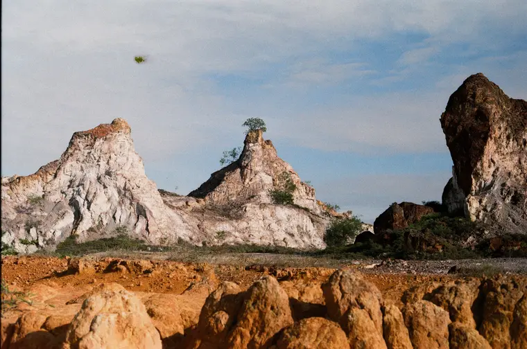White and orange eroded spires with a small tree on top, Sepang South Africa on film