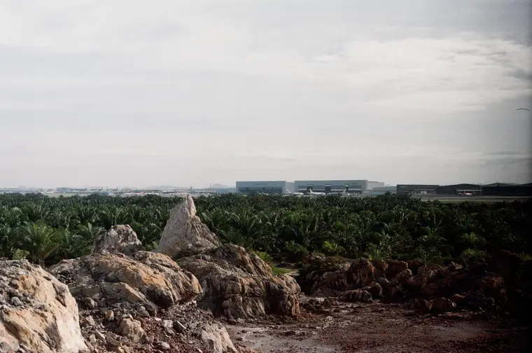 Rocks in the foreground with low buildings on the far horizon