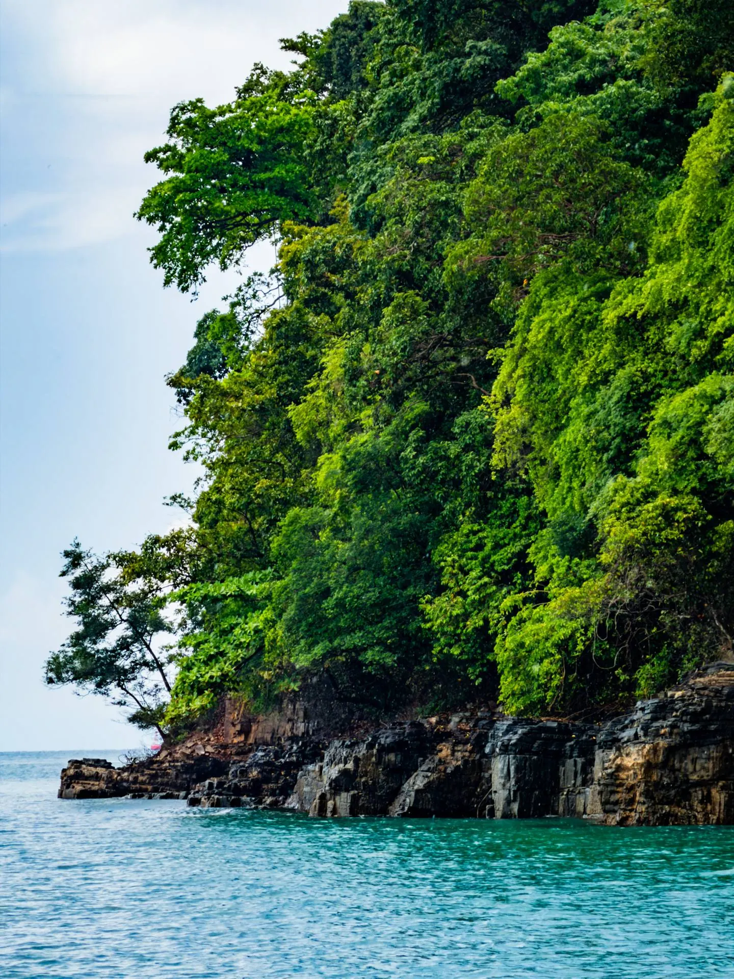 Limestone cliffs and green islands during Langkawi island hopping boat trip