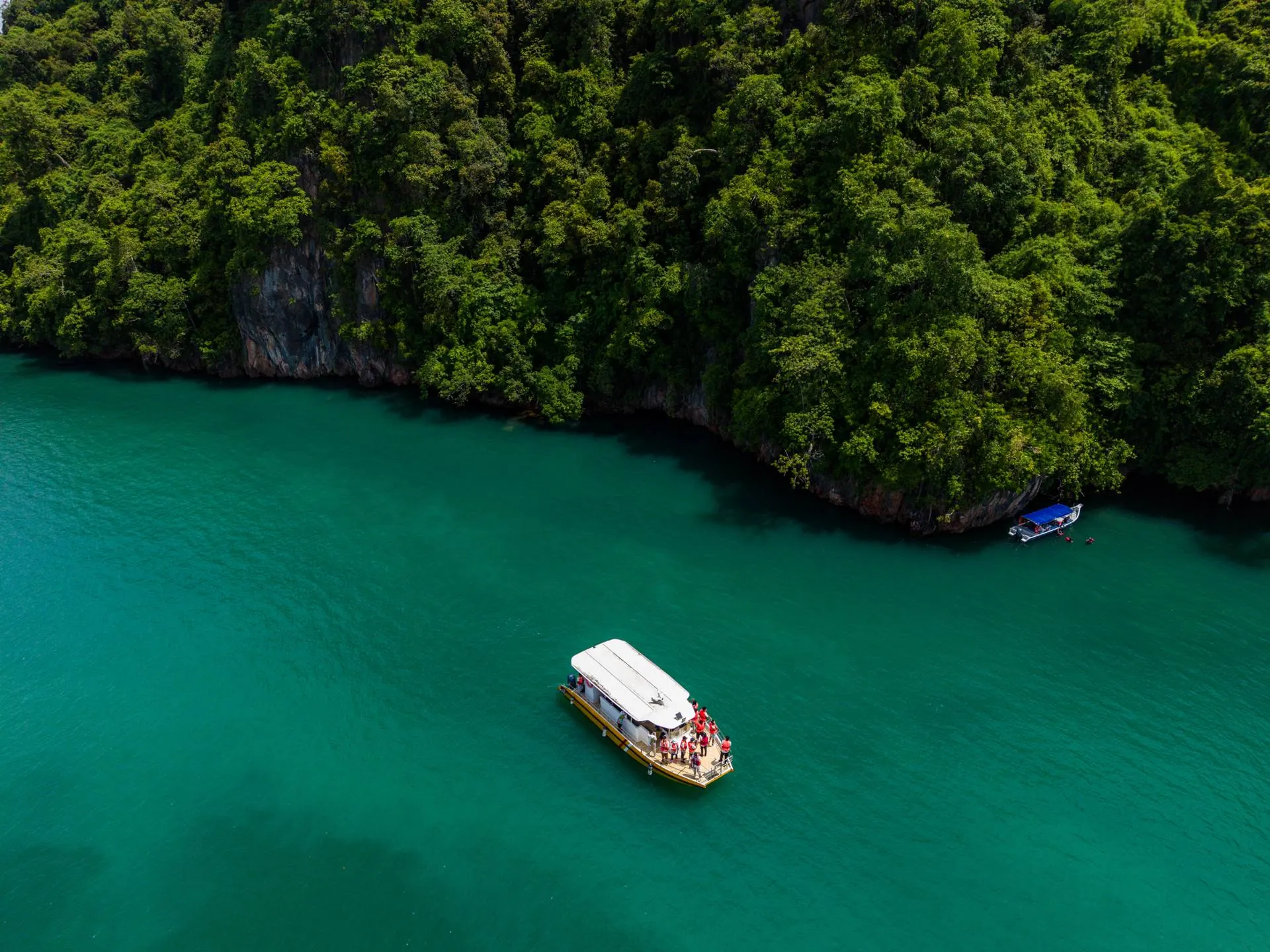 Aerial of mangrove islands and a boat on the Kubang Badak BioGeoTrail