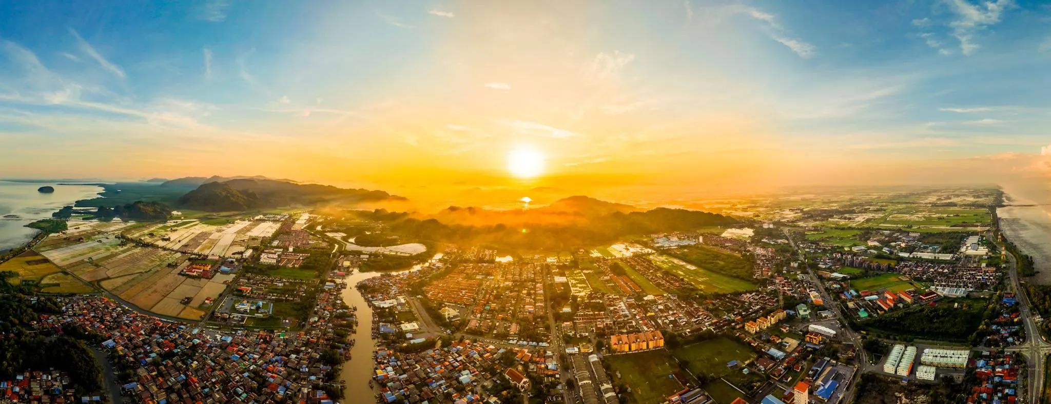 Aerial sunrise panorama over Kuala Perlis town and paddy fields, the mainland gateway to Langkawi