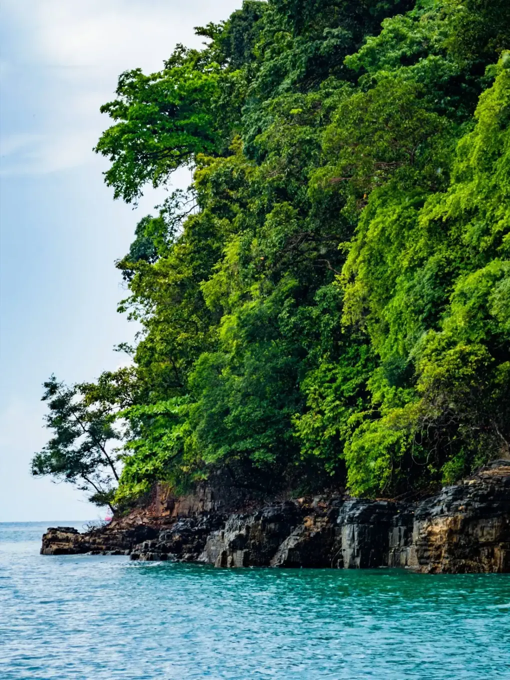 Limestone cliffs and green islands during Langkawi island hopping boat trip